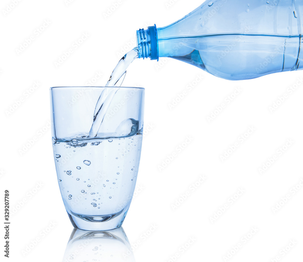 Pouring of fresh water in glass on white background Pouring of fresh water in glass on white background