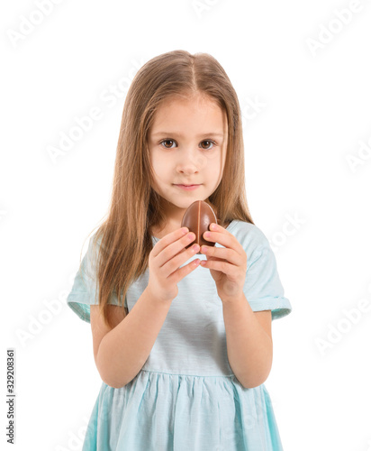 Cute little girl with sweet chocolate egg on white background