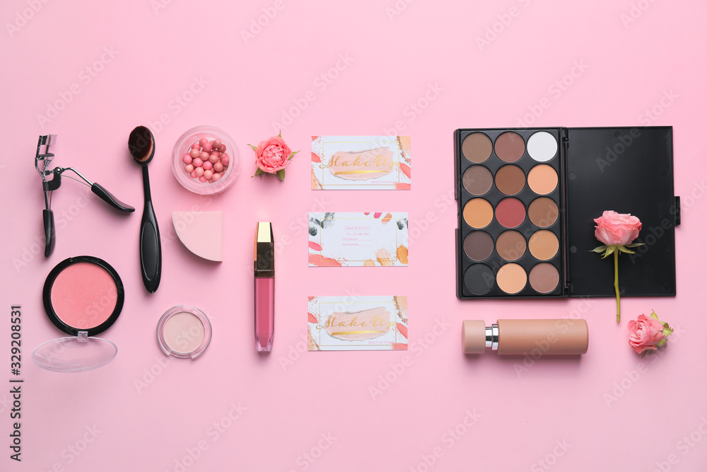 Fototapeta Decorative cosmetics and accessories with business cards of makeup artist on color background