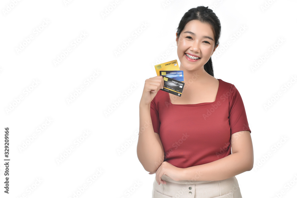 Beautiful Asian woman holding up a credit card with fresh, happily and big smile face in white isolated background. Finance Credit Card, Purchase, online shopping concept. Beautiful Asian woman holding up a credit card with fresh, happily and big smile face in white isolated background. Finance Credit Card, Purchase, online shopping concept.