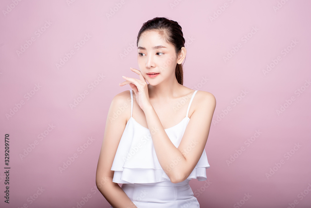 Asian woman poses for healthy skin beauty in pink seamless background. Cosmetic, skincare, surgery concept with copy space. Her skin and face are healthy, beautiful, fresh and youthful. Asian woman poses for healthy skin beauty in pink seamless background. Cosmetic, skincare, surgery concept with copy space. Her skin and face are healthy, beautiful, fresh and youthful.