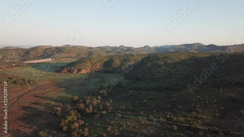 4K aerial drone video of greeen savanna hills and Avis Dam near historical railway bridge on main B6 road from Windhoek to Gobabis in central highland Khomas Hochland of Namibia, southern Africa photo