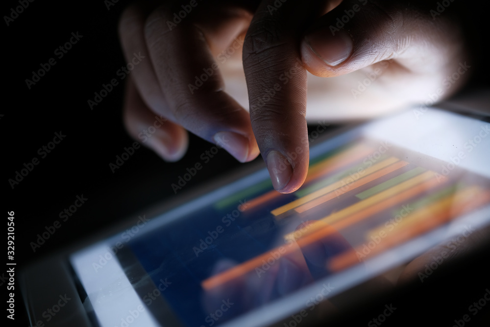 Close up of man hand analyzing chart on digital tablet 