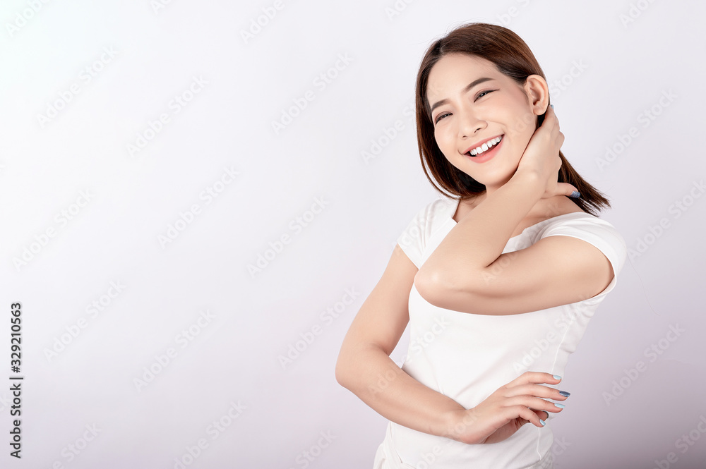 Asian pretty woman in white t-shirt and white pants pretending glad happy face with copy space on white background. Information telling, shopping promotion, announcement, selling support concept. Asian pretty woman in white t-shirt and white pants pretending glad happy face with copy space on white background. Information telling, shopping promotion, announcement, selling support concept.