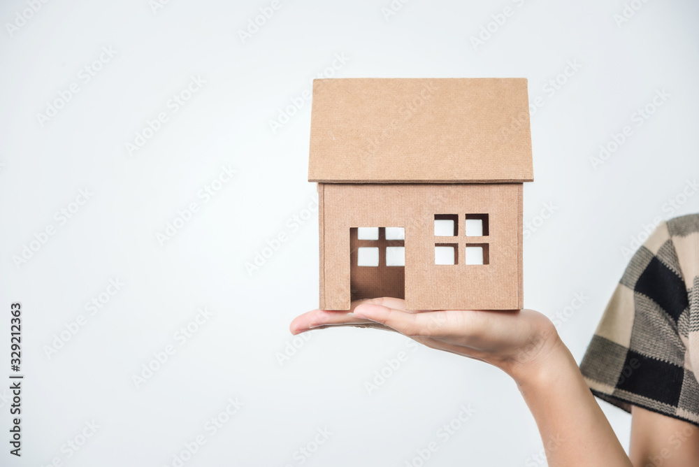 Young beautiful asian woman holding a house in her hands, black hairs. Young beautiful asian woman holding a house in her hands, black hairs.