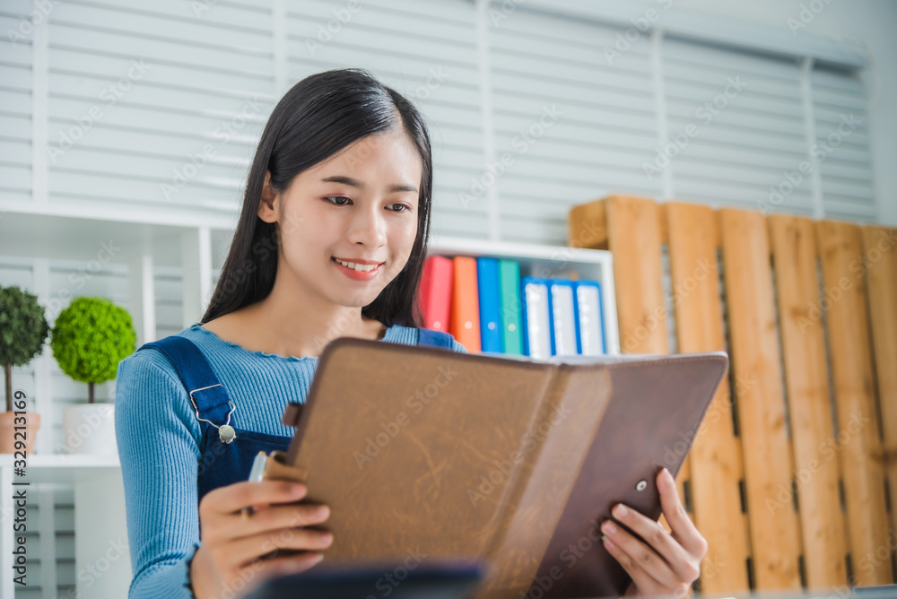 Portrait of young female smile charming lady with notebook paper, Attractive asian woman feeling happy. Portrait of young female smile charming lady with notebook paper, Attractive asian woman feeling happy.
