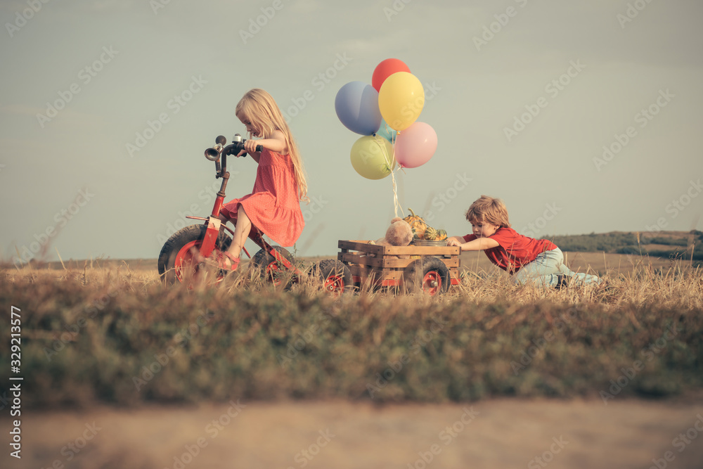 International childrens day. Children play outdoors. Only fun is on my mind. Little girl and boy enjoy life and nature. Happy little kids. Happy smiling children on nature background. - obrazy, fototapety, plakaty 