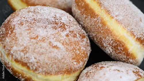 Fresh made Berliner Doughnuts rotating on a plate (seamless loopable)