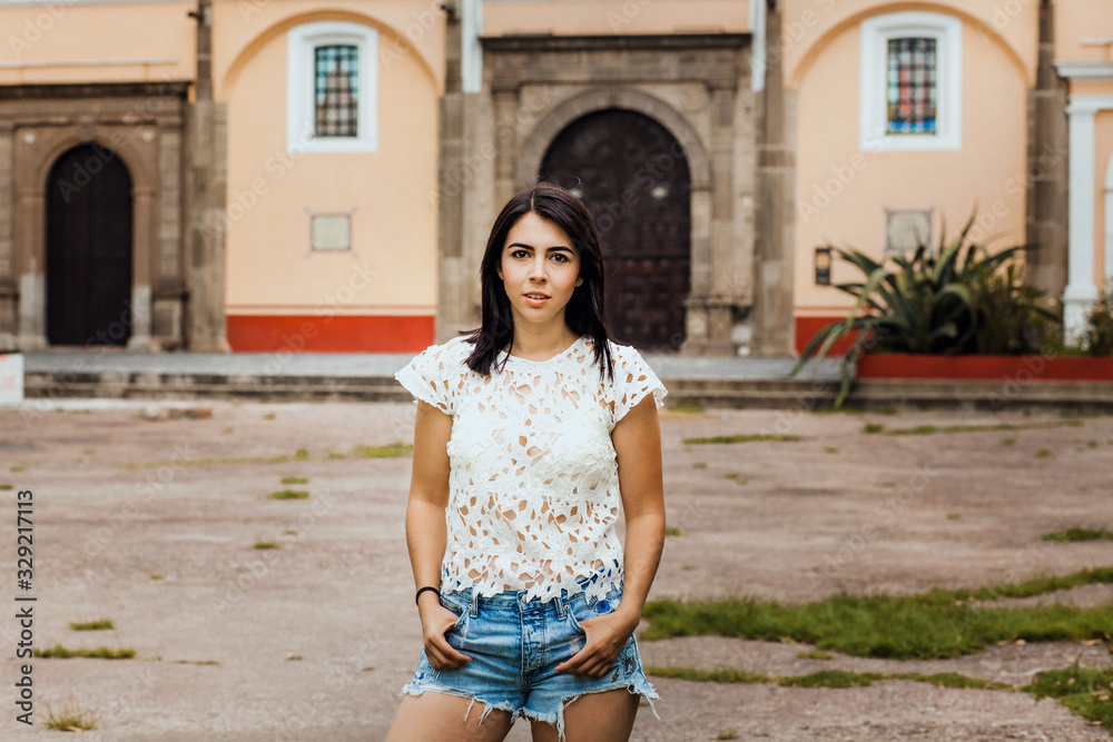 Mexican woman portrait looking happy and smiling in a colonial city in Mexico City