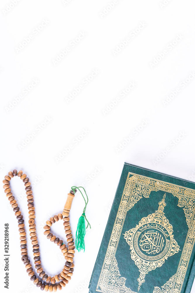 Qoran and Tasbih (rosary beads). Islamic Concept. The words on the Qoran is arabic words which means 