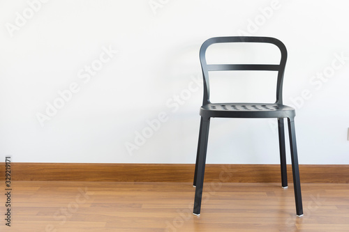 Black metal chair in empty room. Series of furniture.
