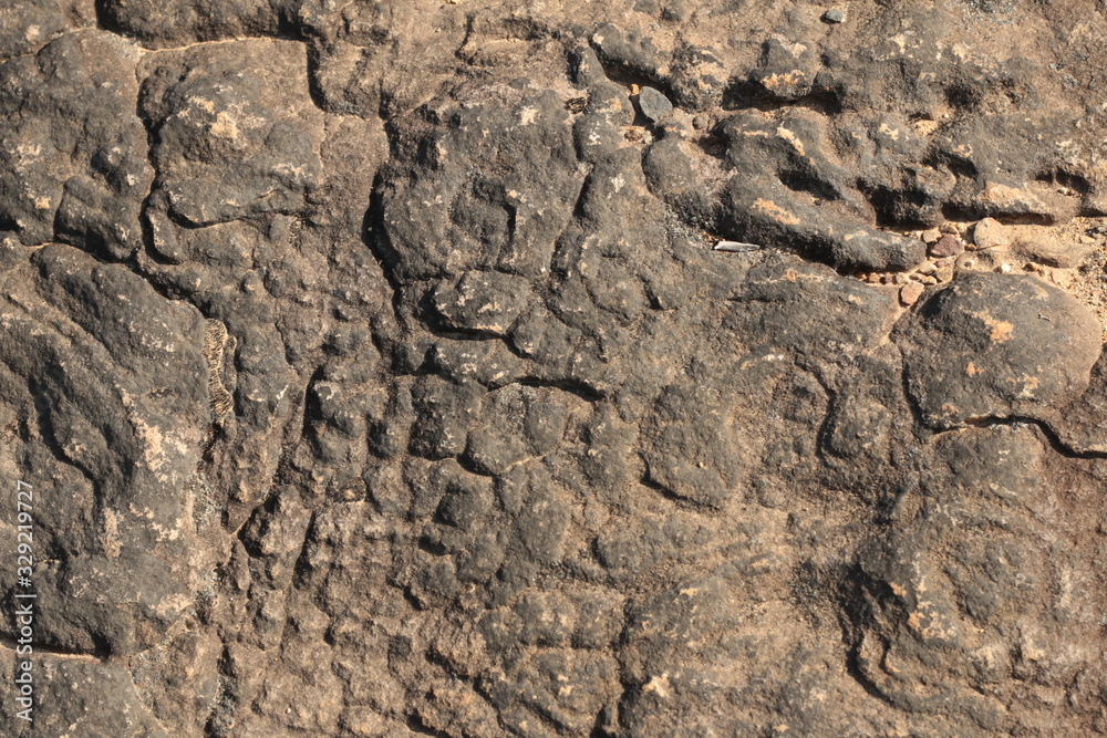 textures and patterns showing the formation of stone from ancient cooled lava flow on rock faces in a volcanic area rural Victoria, Australia. textures and patterns showing the formation of stone from ancient cooled lava flow on rock faces in a volcanic area rural Victoria, Australia.