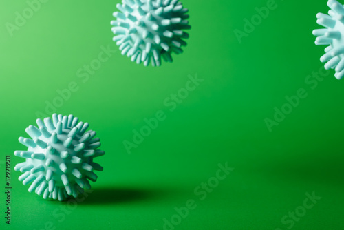 COVID-19 China pathogen respiratory coronavirus  flu outbreak 3D medical simulation. Representation of microscopic view of floating influenza virus cells. Green background with space for text