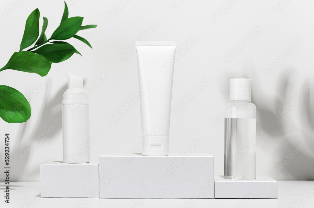 custom made wallpaper toronto digitalCream tube, moisturizing foam in spray and tonic water on shipping boxes. White blank unbranded flacons with cosmetology products. Professional skincare and wellness concept