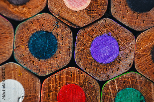 Many wooden crayons that have been used in the dark background are macro images.