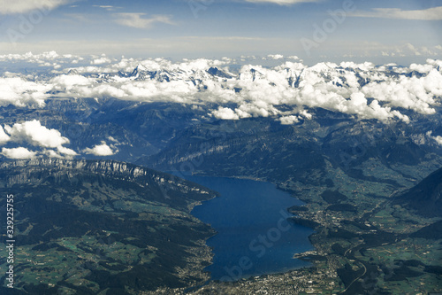 Landscape aerial view of Zurich city, Switzerland, with colorful houses, forest with trees, lake Zurich, hills, and fields