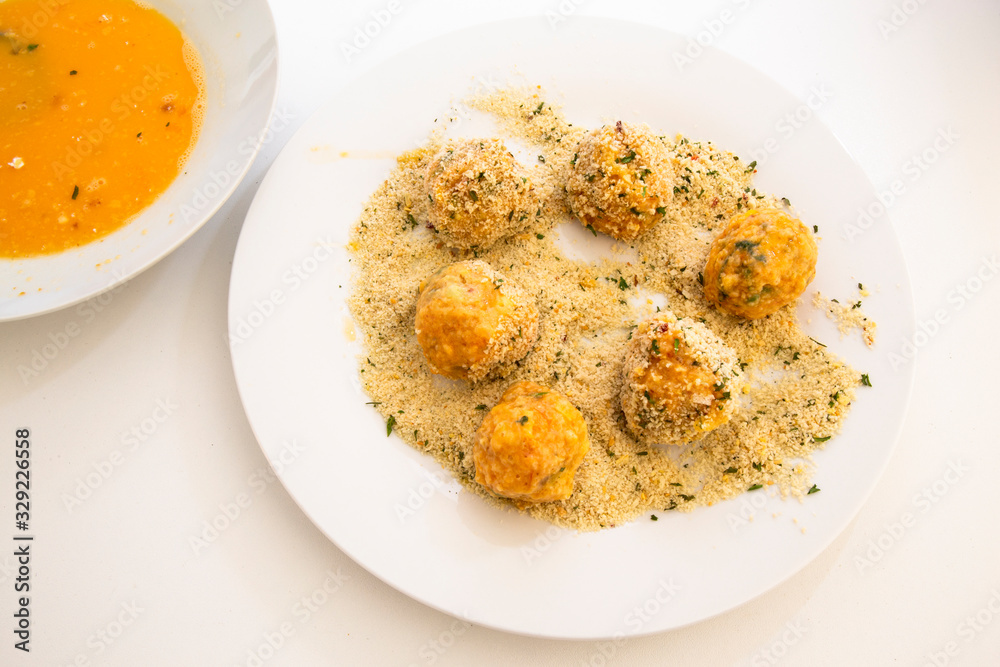 Roll the arancini ball in the breadcrumbs Roll the arancini ball in the breadcrumbs