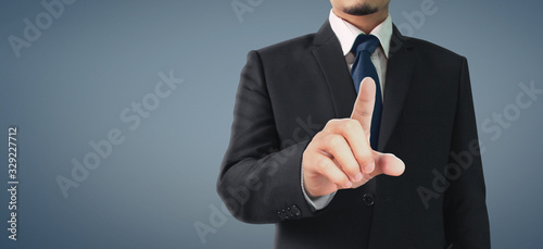 Business portrait of handsome man in black suit.Touch screen