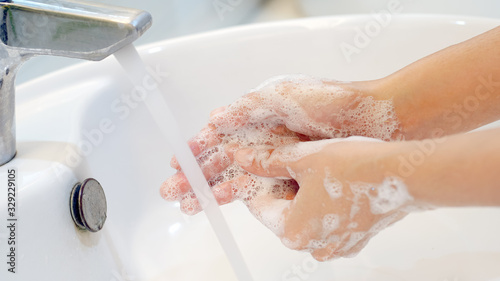 Wash hands.Hygiene concept Wash your hands with soap in the sink.Cover for virus protection. photo