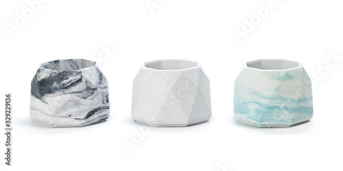 Faceted concrete candle holders. Close up. Isolated on a white background photo