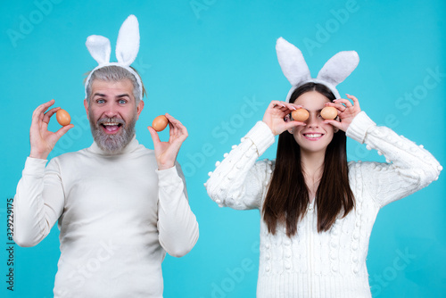 Easter family. Happy couple with bunny ears. photo