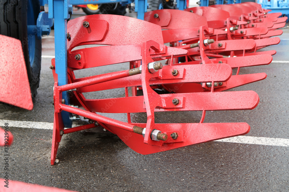 the knife of an agricultural plow. The view is in the reverse side. Adjusting support rods. View from the back.