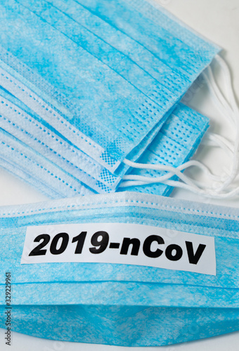 Medical protective dressing with the inscription: 2019-ncov on a white background.Virus epidemic concept. Close up.