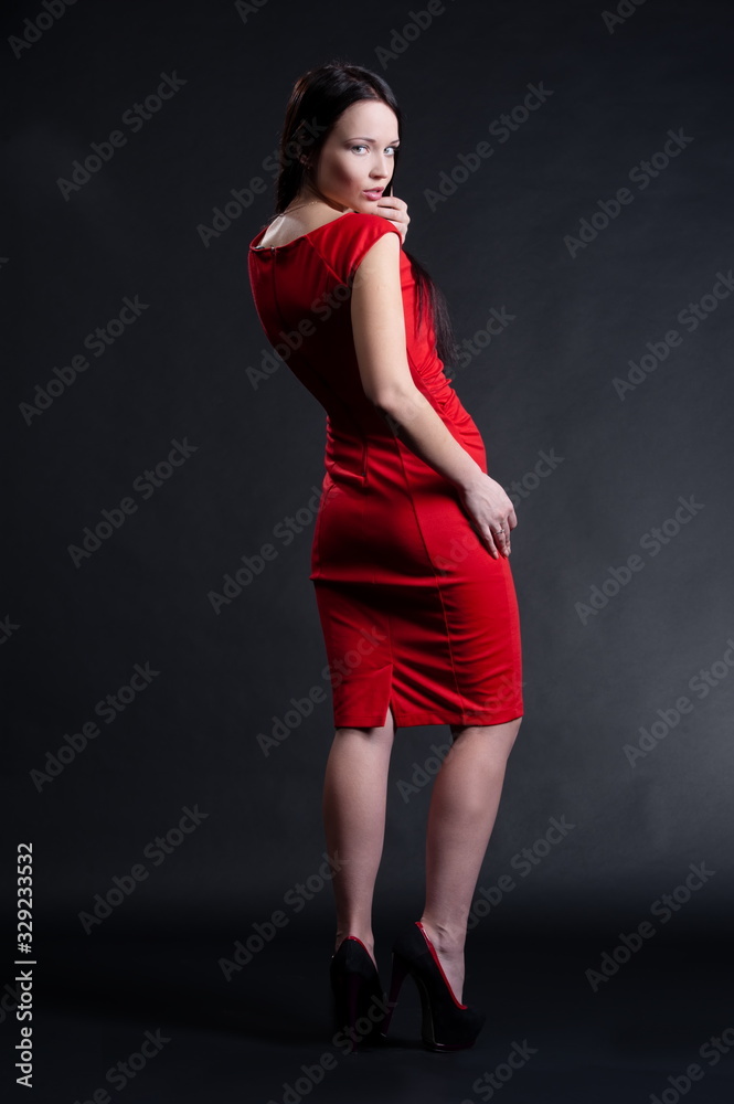 Beautiful sexy brunette girl posing on a black background