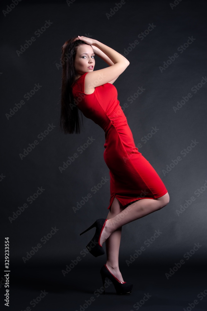 Beautiful sexy brunette girl posing on a black background
