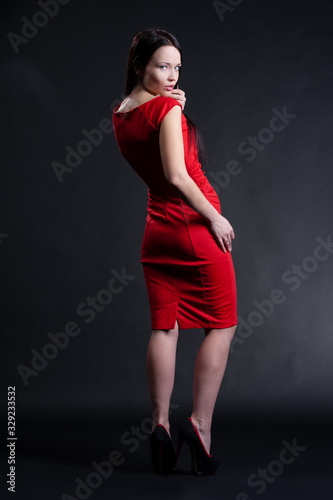 Beautiful sexy brunette girl posing on a black background