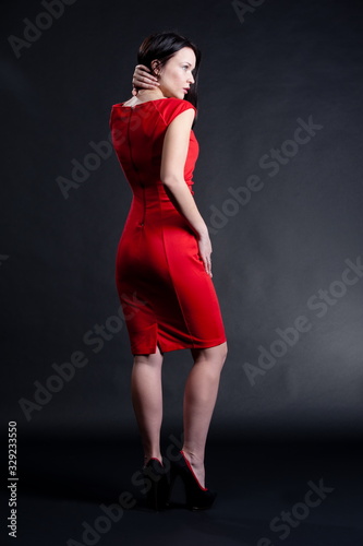 Beautiful sexy brunette girl posing on a black background