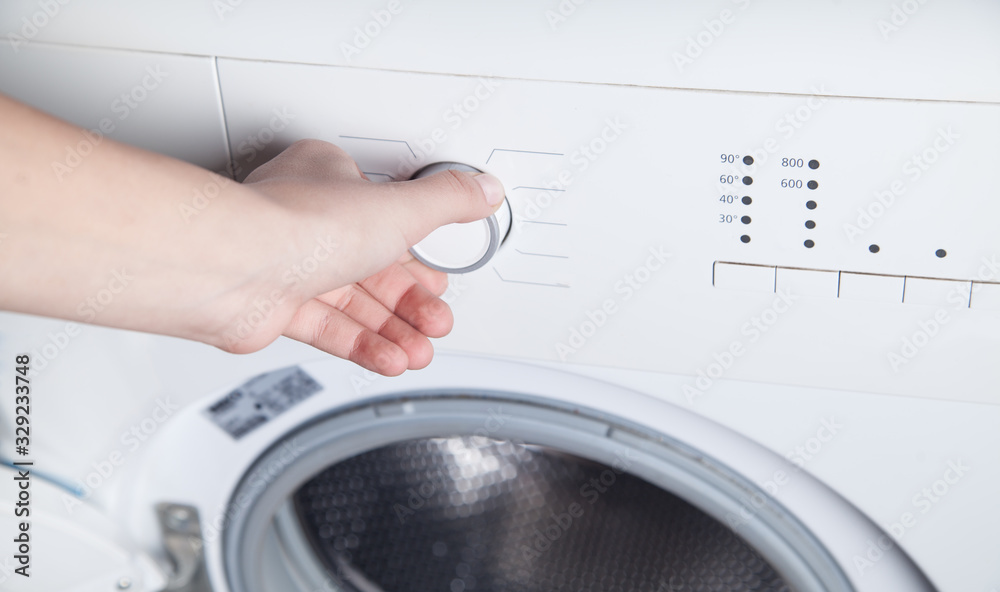 Girl hand is turning knob of washing machine. Girl hand is turning knob of washing machine.
