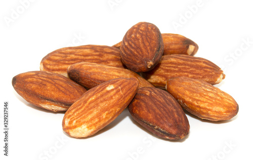 pile of almonds seeds isolated on white background