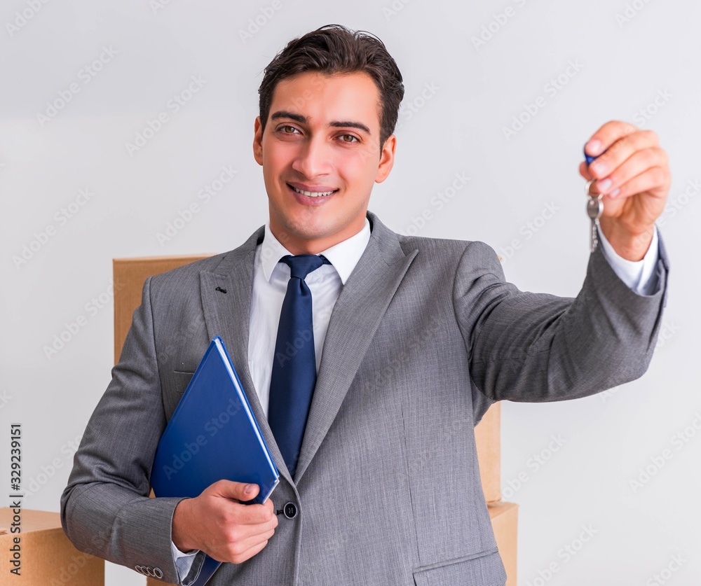 Real estate agent with key from new house Real estate agent with key from new house