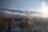 wet window after rain on the background of the rising sun. beautiful spring weather