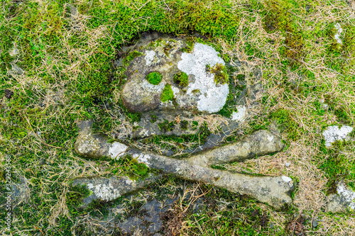 GARDENSTOWN, SCOTLAND - 2016 OCTOBER 22. Skull and crossbones on tombstone grave. photo