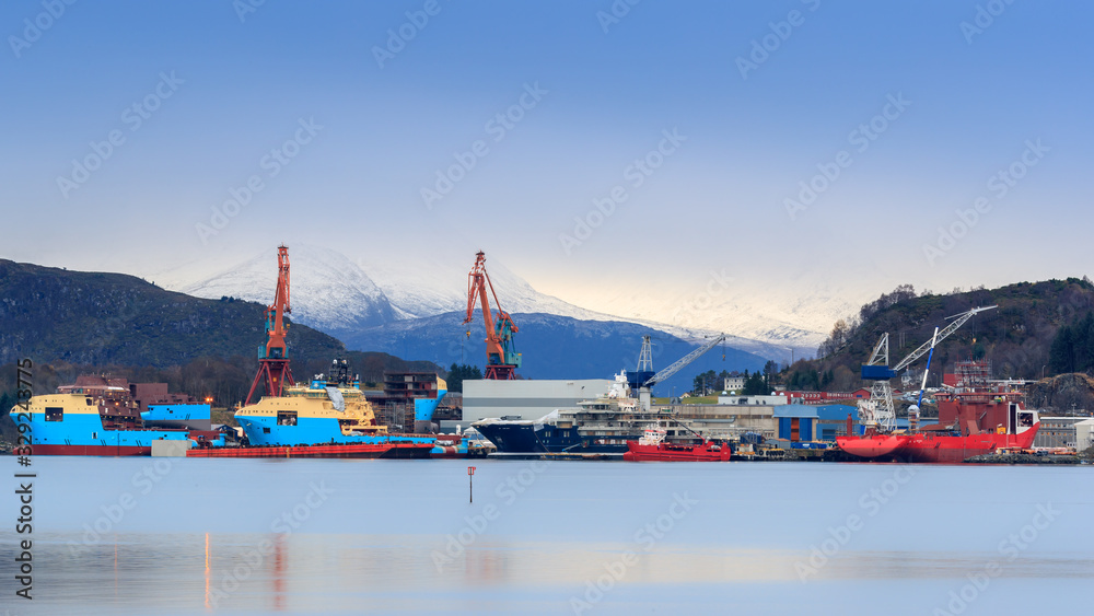 ULSTEINVIK, NORWAY - 2016 NOVEMBER 22. Big activity at Kleven Yard with three Maersk AHTS vessels, one private yacht named Ulysses and one offshore cable vessel NKT Victoria.