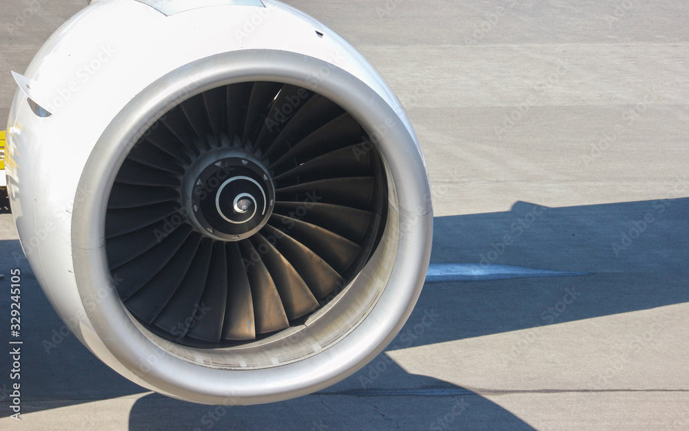 Turbine engine part of airplane with airport runway as background. Turbine engine part of airplane with airport runway as background.