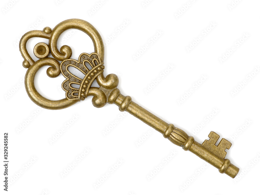 old brass key against a white background