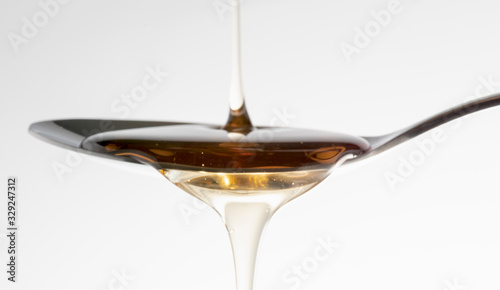Natural Honey syrup on the spoon