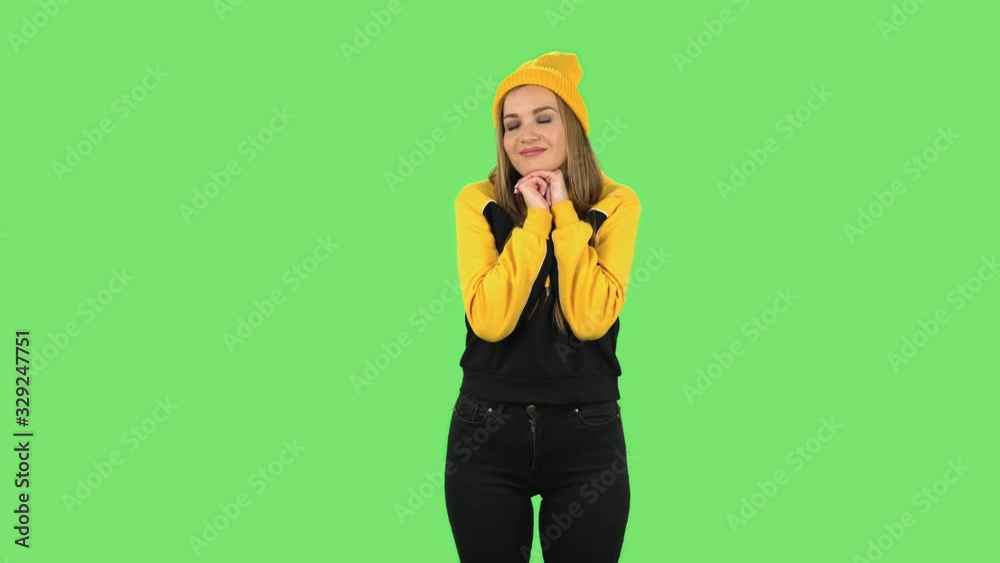 Modern girl in yellow hat is daydreaming and smiling looking up. Green screen Modern girl in yellow hat is daydreaming and smiling looking up. Green screen