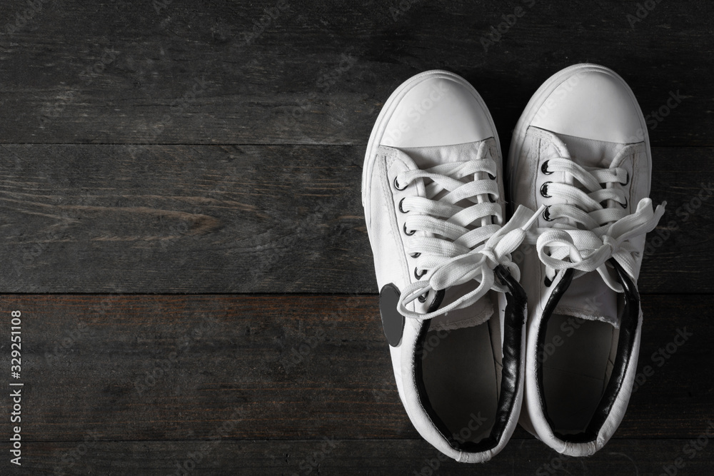 Exercise White Shoes on wooden table background. Exercise White Shoes on wooden table background.