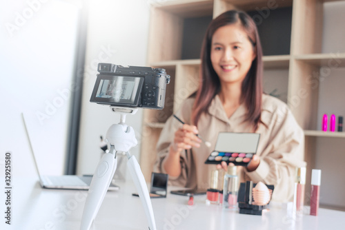 Makeup Beauty fashion blogger recording video presenting cosmetics at home influencer on social media concept.