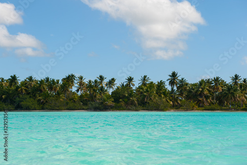 Beautiful view on the beach on Saona Island. White sand and palm trees and blue sea and chaise longues © galika