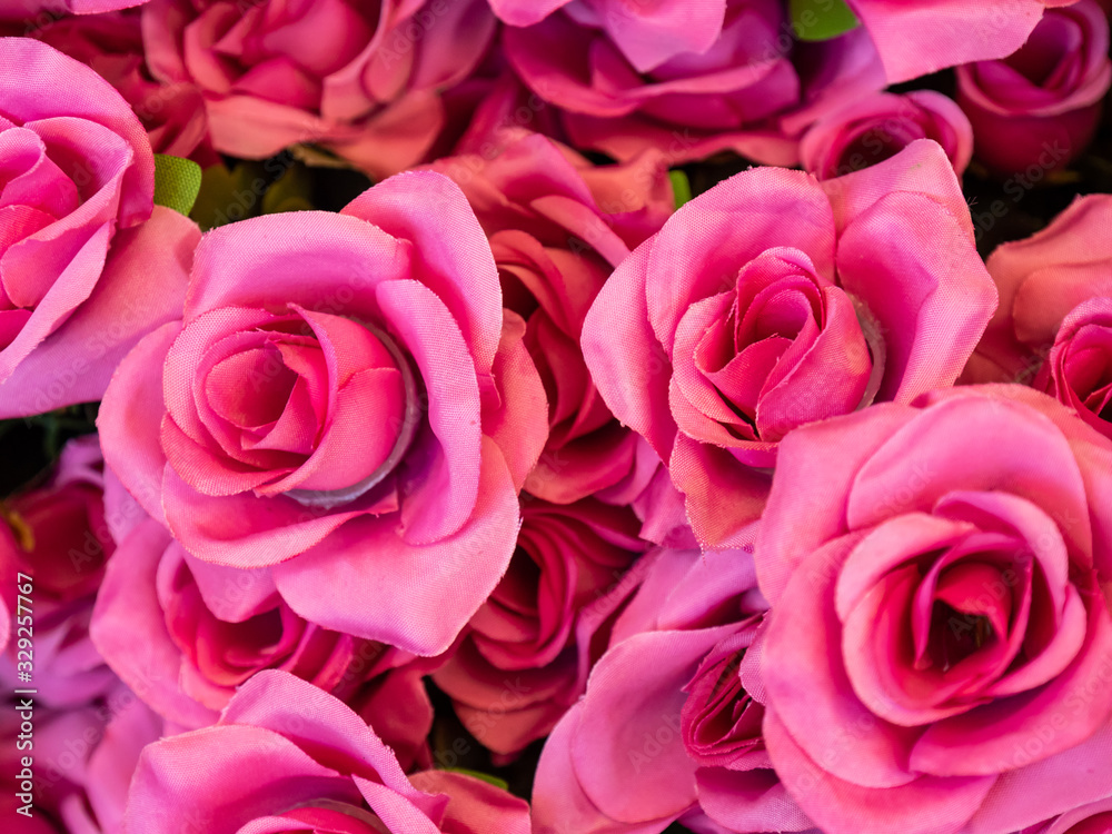 Close up imitation or artificial red rose flower background. Selective focus. Close up imitation or artificial red rose flower background. Selective focus.