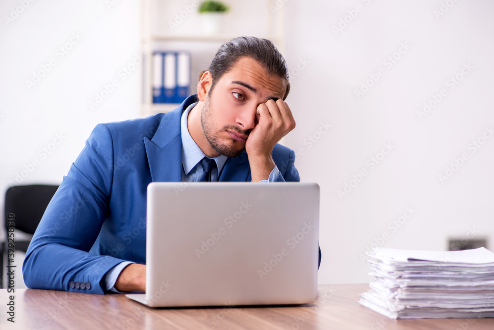 Young male businessman working in the office Young male businessman working in the office