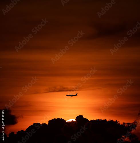 Silhouette of passenger airplane with the morning sunrise background © hit1912