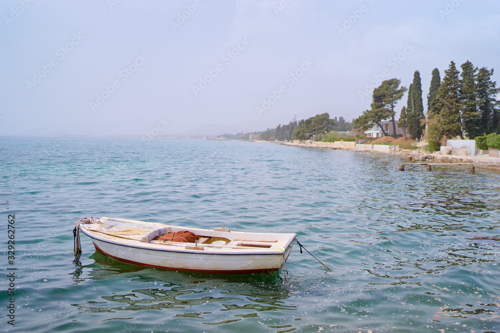 Naklejka premium Beautiful landscape with seashore and fishing boat.