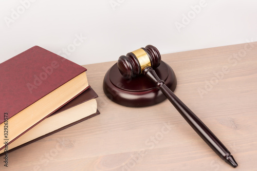 Wooden judges gavel on wooden table, close up. Space for text