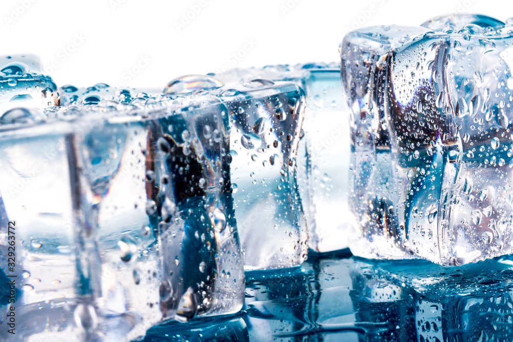 ice cubes and water drops close up on blue and white background ice cubes and water drops close up on blue and white background